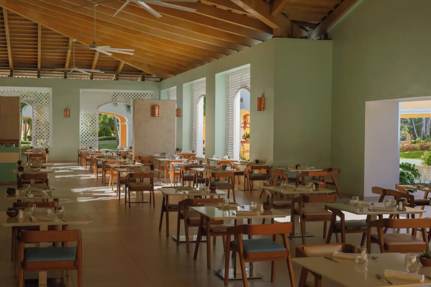 Open-air dining room with arched windows at Iberostar Selection Hacienda Dominicus.