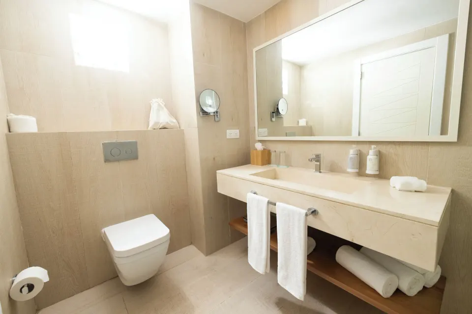 Suite bathroom with vanity and wall-mounted toilet at Iberostar Selection Hacienda Dominicus.
