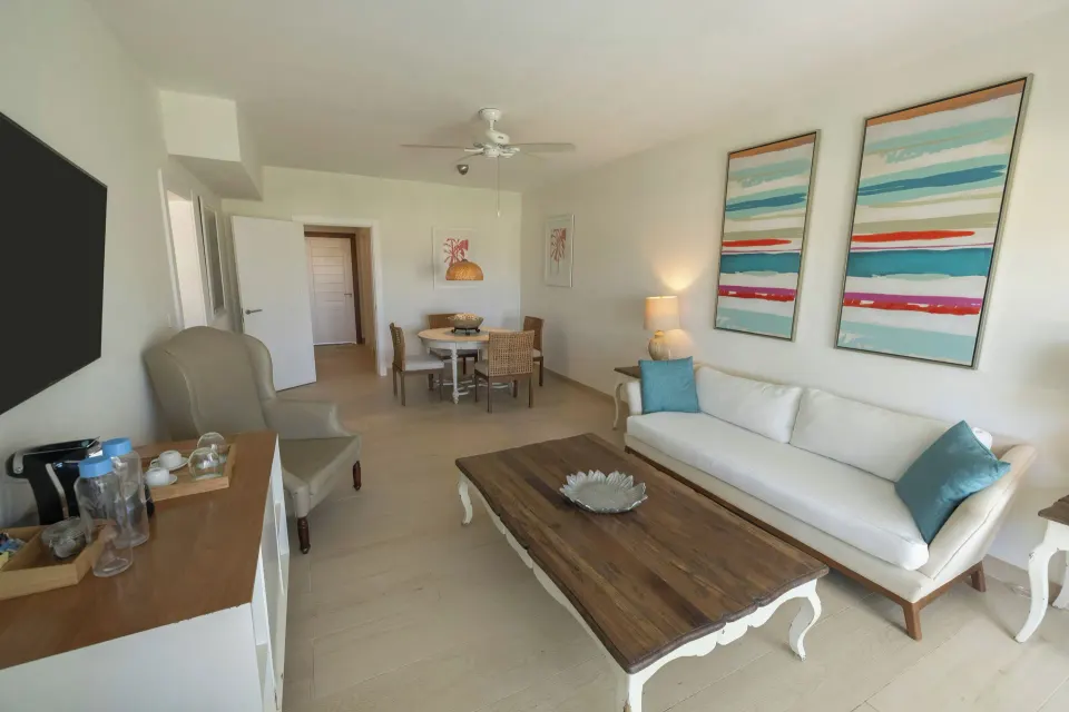 Suite living room with sofa and dining table at Iberostar Selection Hacienda Dominicus.
