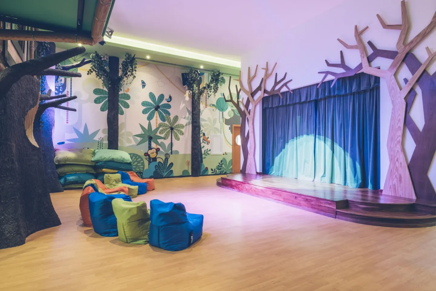 A colorful children’s stage and beanbag seating at Iberostar Selection Paraíso Lindo.