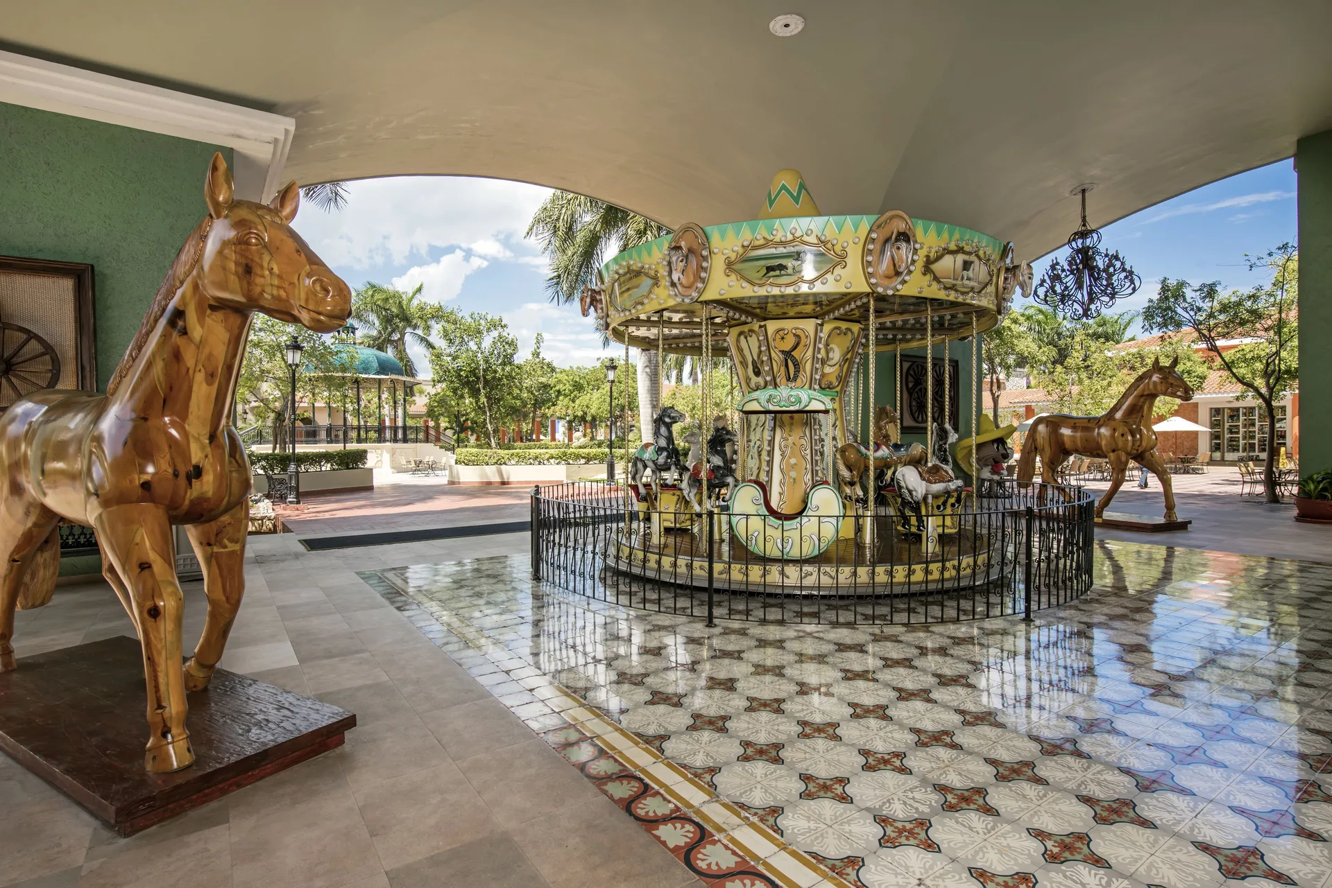 Covered carousel area with horse figures at Iberostar Selection Paraíso Lindo.
