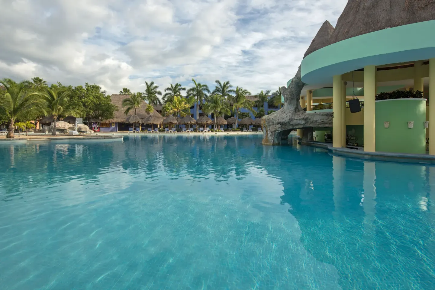 Large pool beside a curved swim-up bar area at Iberostar Selection Paraíso Lindo.