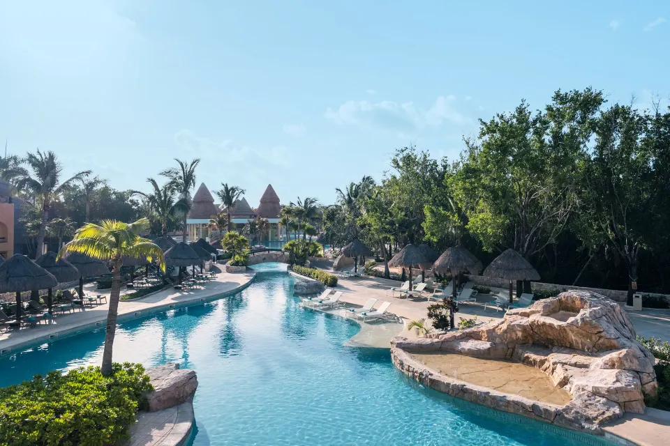 Winding pool with loungers and palapas at Iberostar Selection Paraíso Lindo.