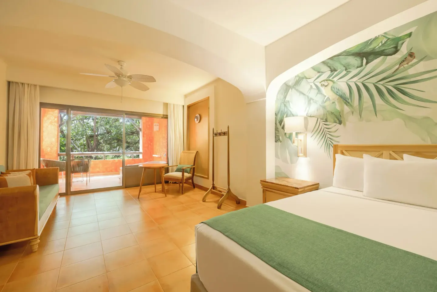 Junior Suite pure Wellness king bed and sitting area at Iberostar Selection Paraíso Lindo.