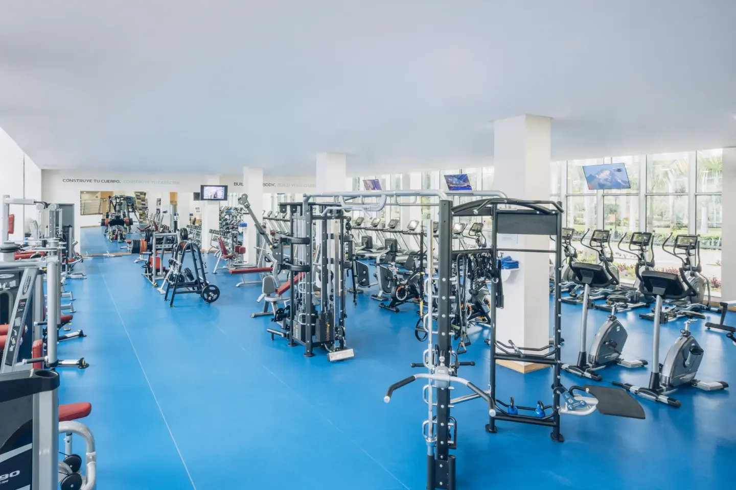 Fitness center with weight machines and cardio equipment at Iberostar Selection Paraíso Maya Suites.