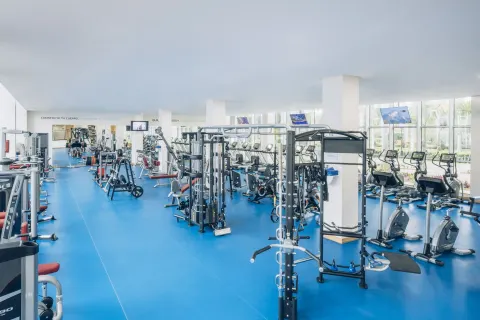 Fitness center with weight machines and cardio equipment at Iberostar Selection Paraíso Maya Suites.