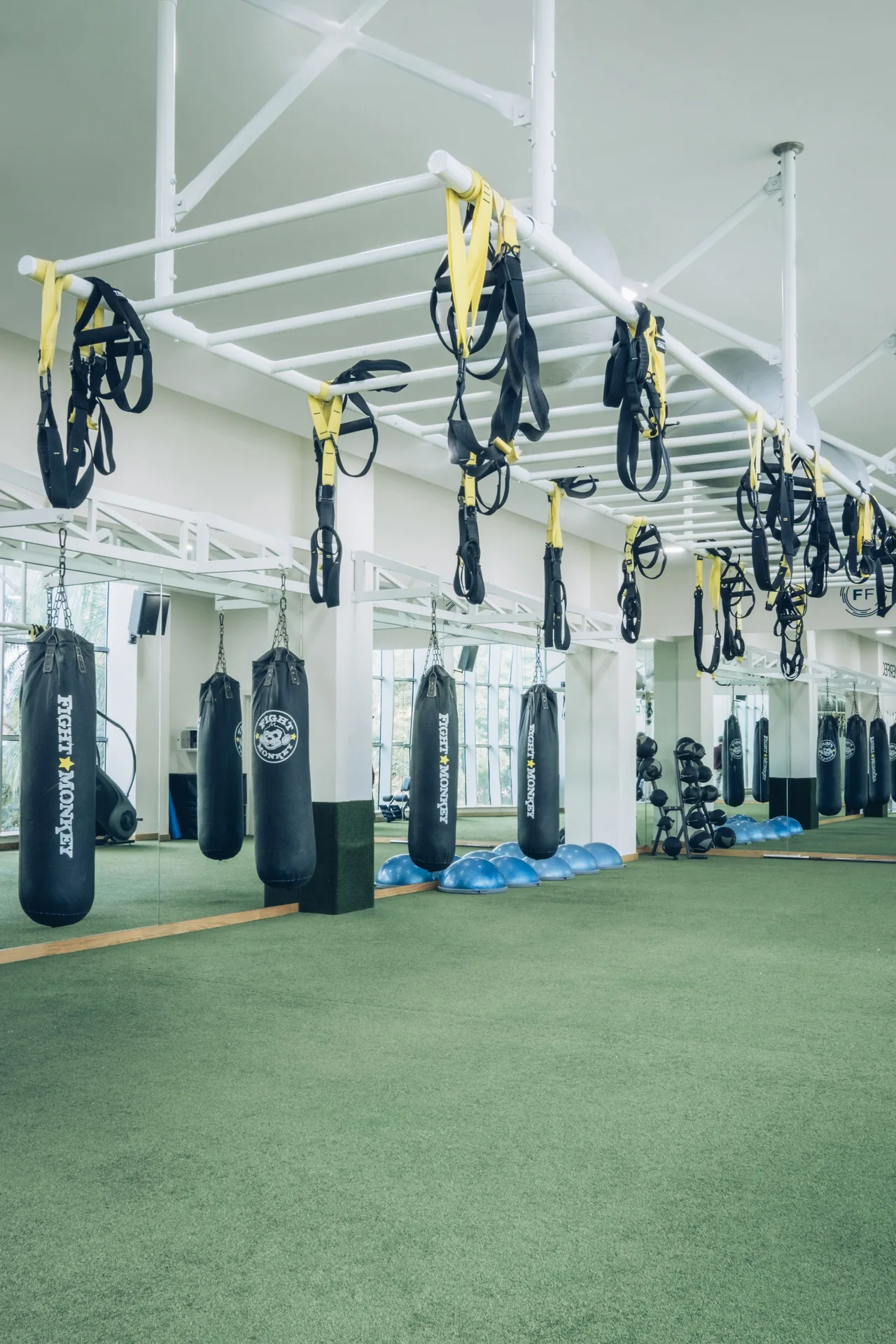 Gym area with suspension straps and punching bags at Iberostar Selection Paraíso Maya Suites.