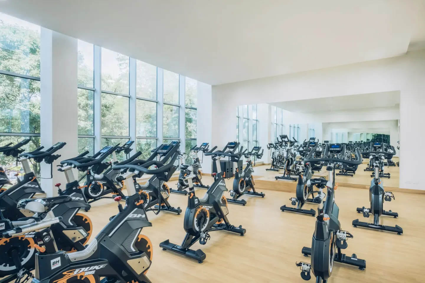 Indoor cycling studio with rows of spin bikes at Iberostar Selection Paraíso Maya Suites.