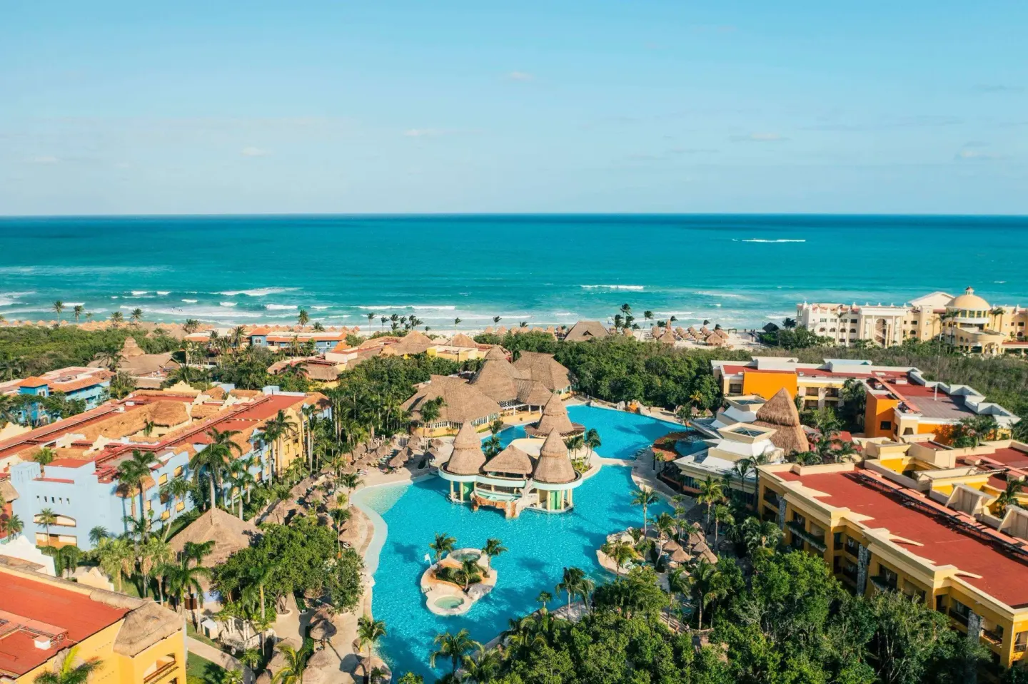 Aerial view of resort pools and the Caribbean coastline at Iberostar Selection Paraíso Maya Suites.