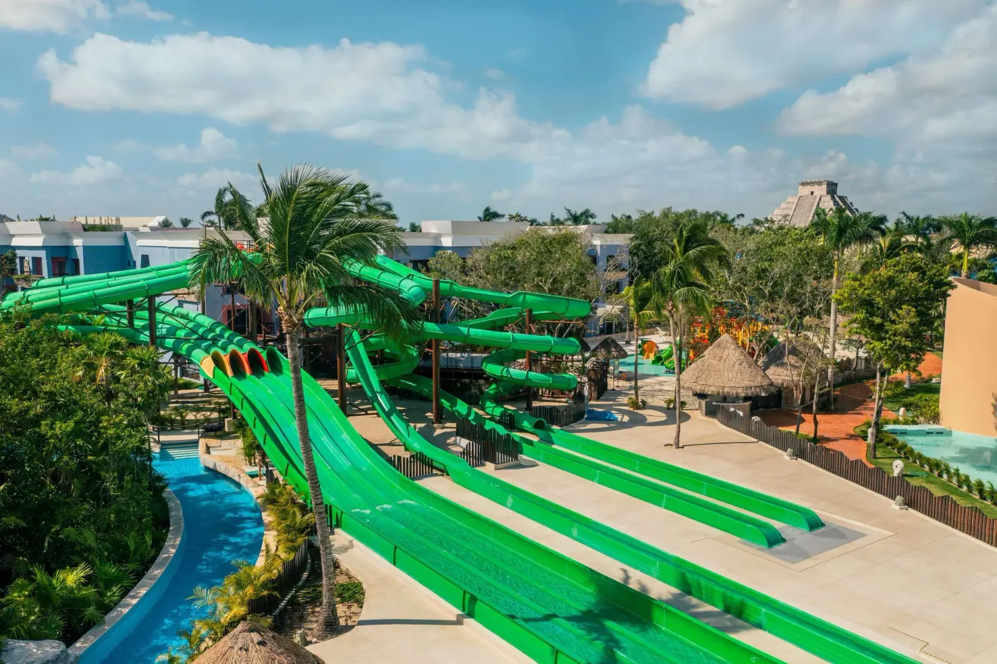 Green water slides and lazy river area at Iberostar Selection Paraíso Maya Suites.