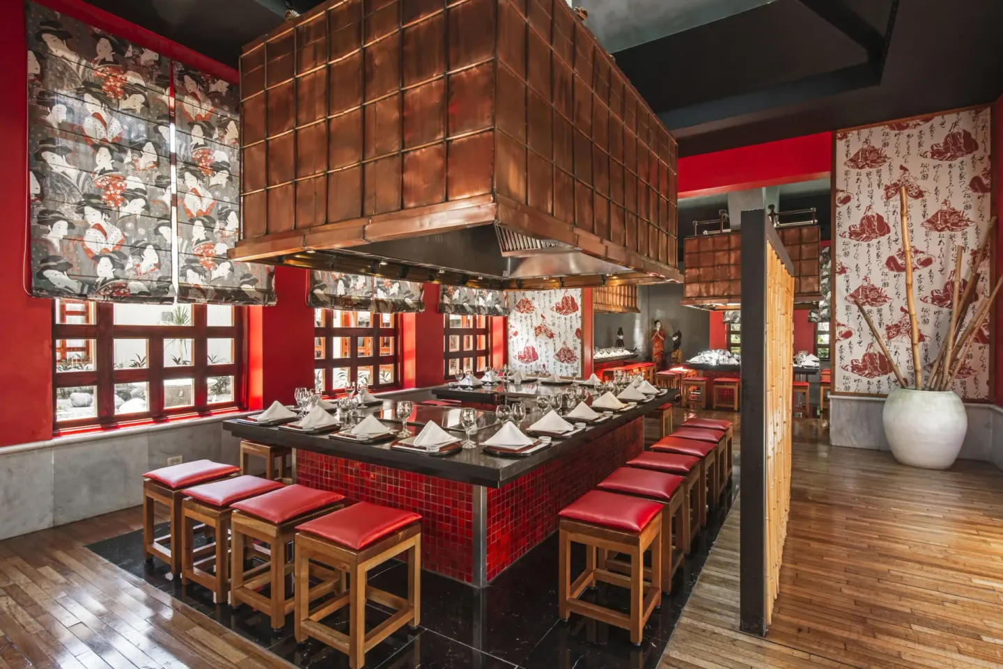 Teppanyaki grill counter with red stools at Iberostar Selection Paraíso Maya Suites.