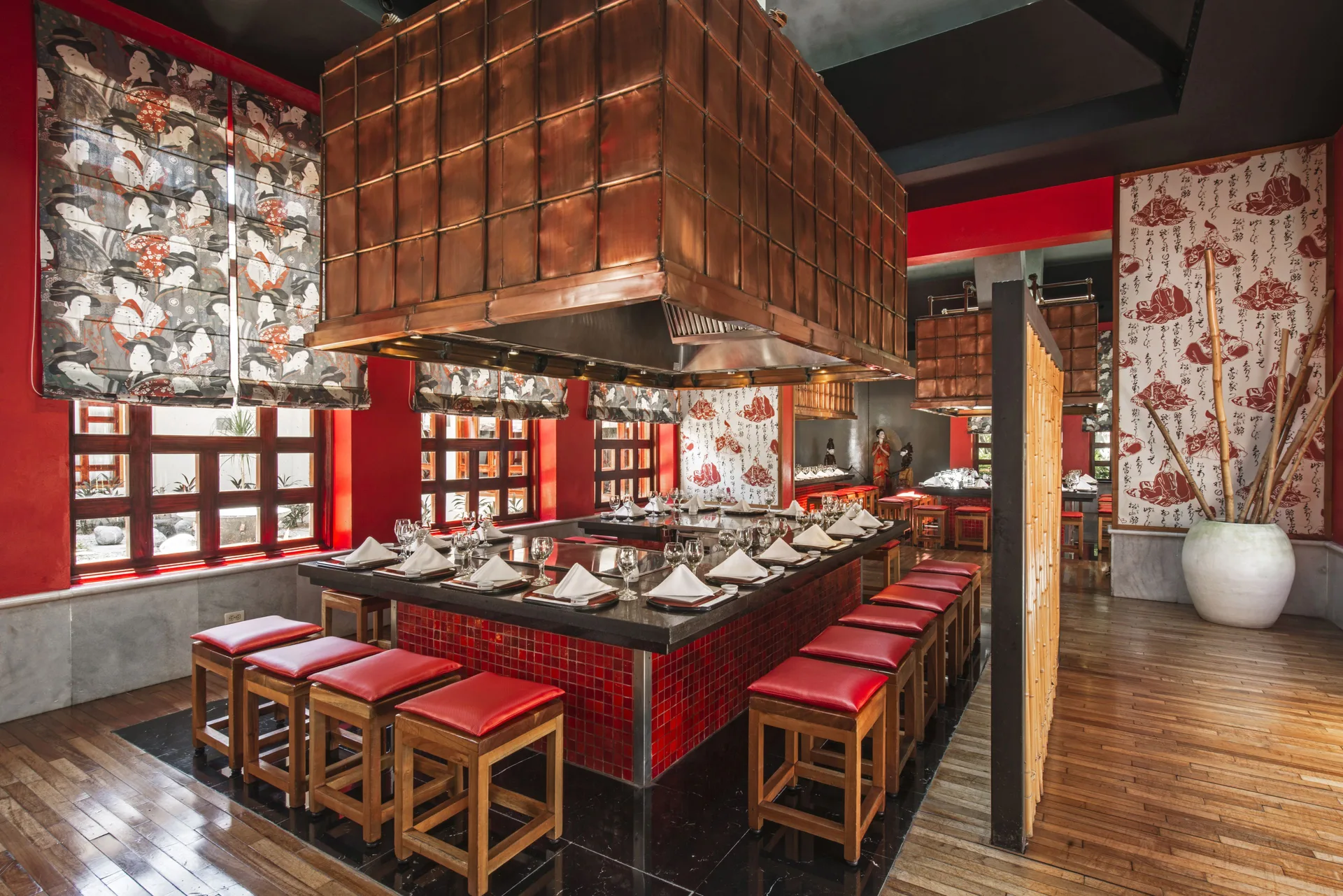 Teppanyaki grill counter with red stools at Iberostar Selection Paraíso Maya Suites.