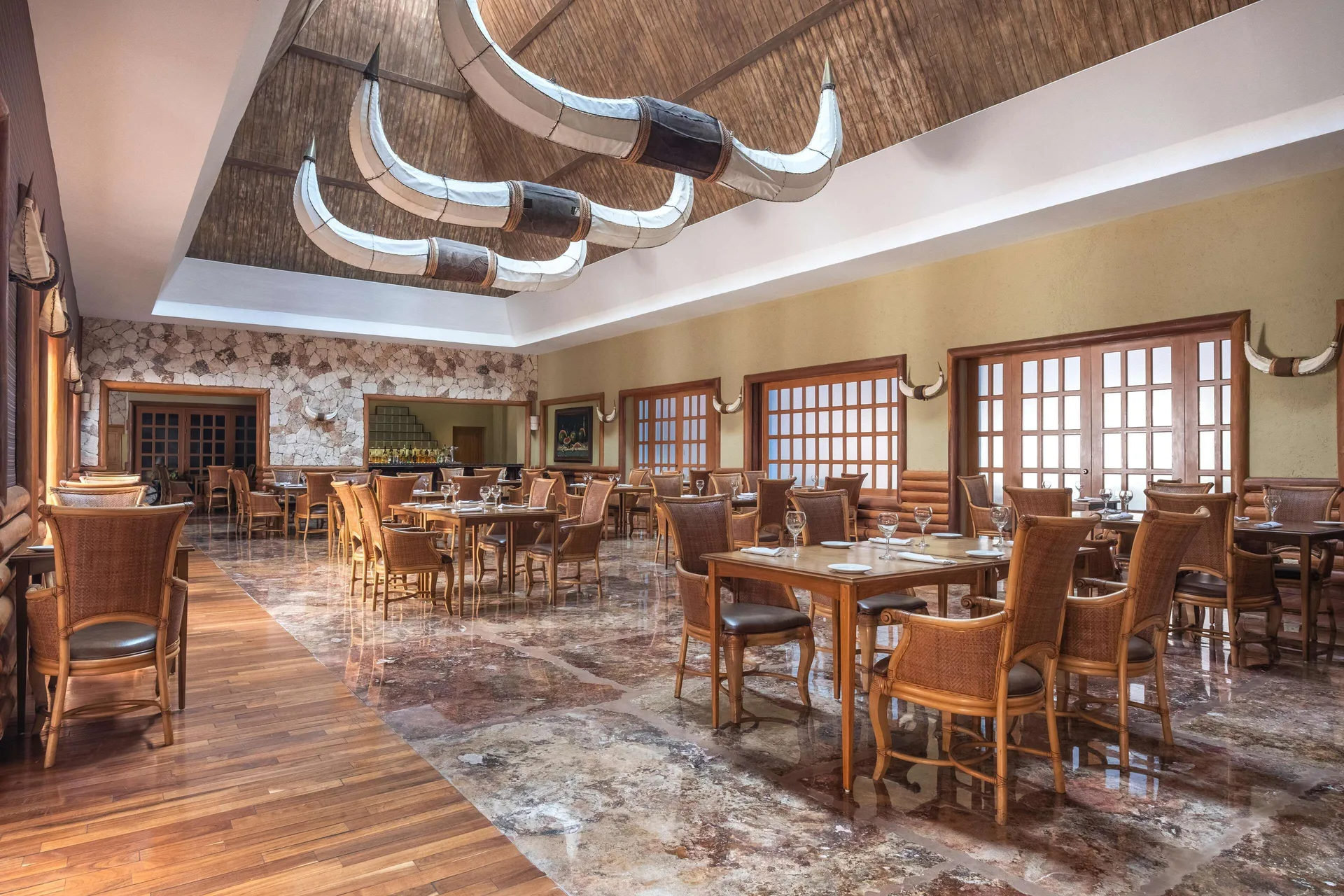 Steakhouse-style dining room with horn decor at Iberostar Selection Paraíso Maya Suites.