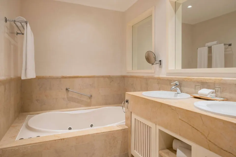 Junior Suite bathroom with tub and double sinks at Iberostar Selection Paraíso Maya Suites.