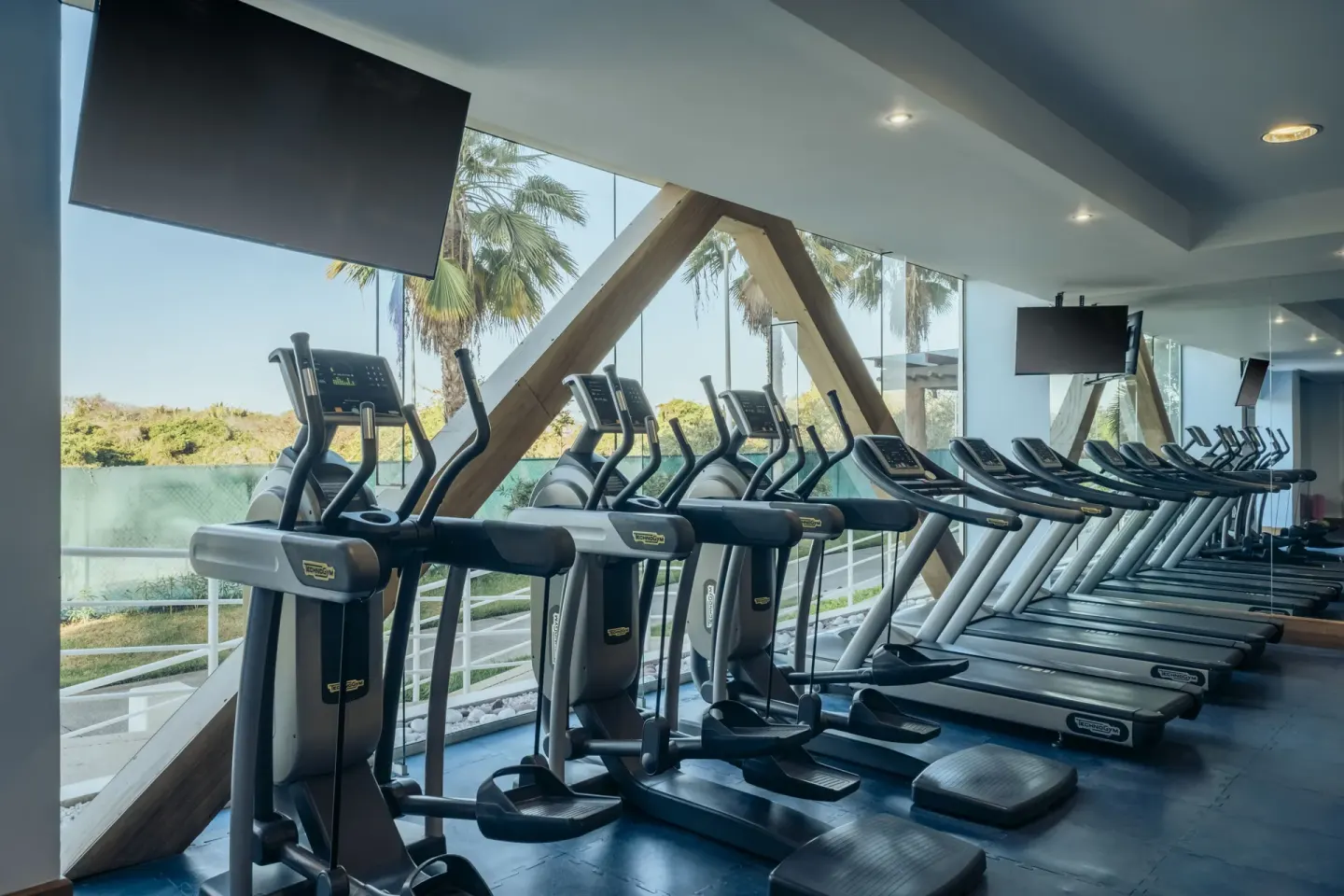 Rows of treadmills and elliptical machines in the gym at Iberostar Selection Playa Mita.