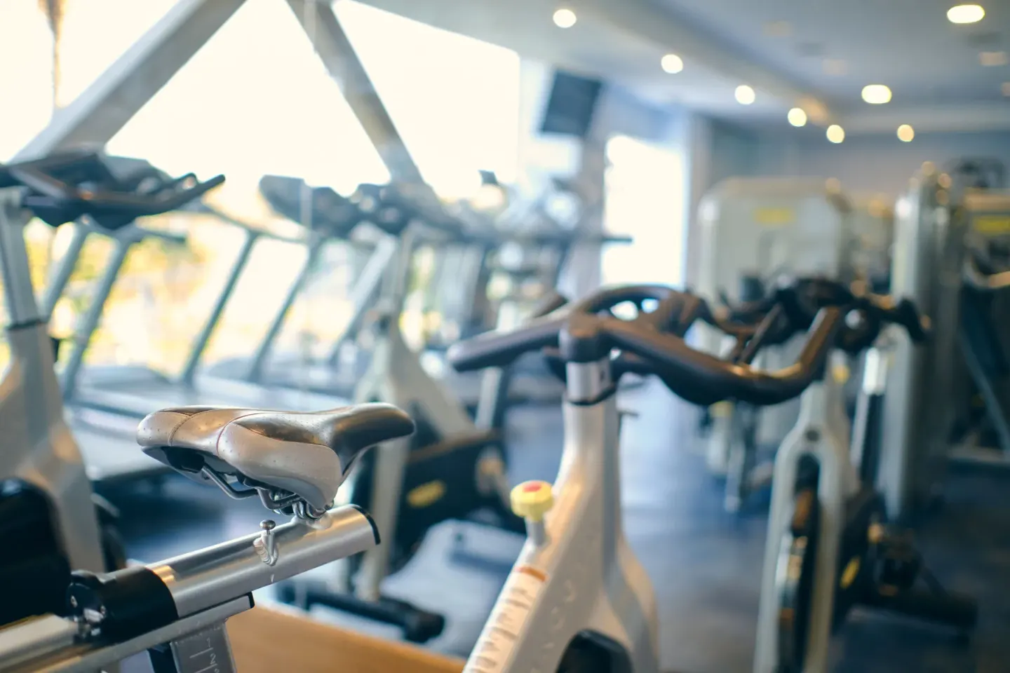 Exercise bike foreground with gym equipment behind at Iberostar Selection Playa Mita.
