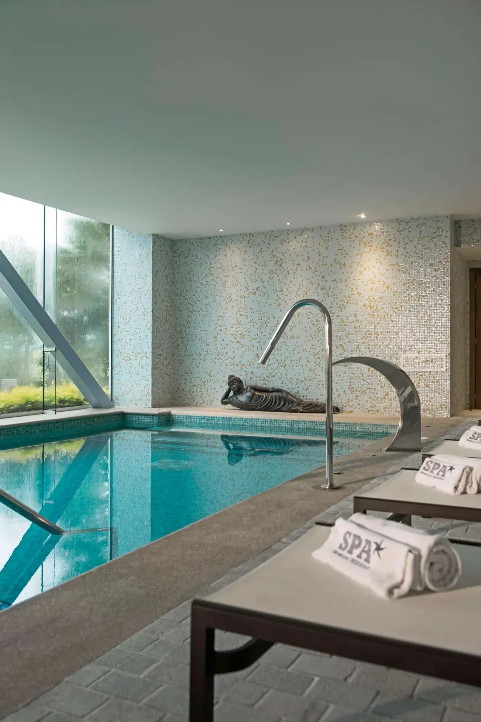Indoor spa pool with loungers and mosaic walls at Iberostar Selection Playa Mita.