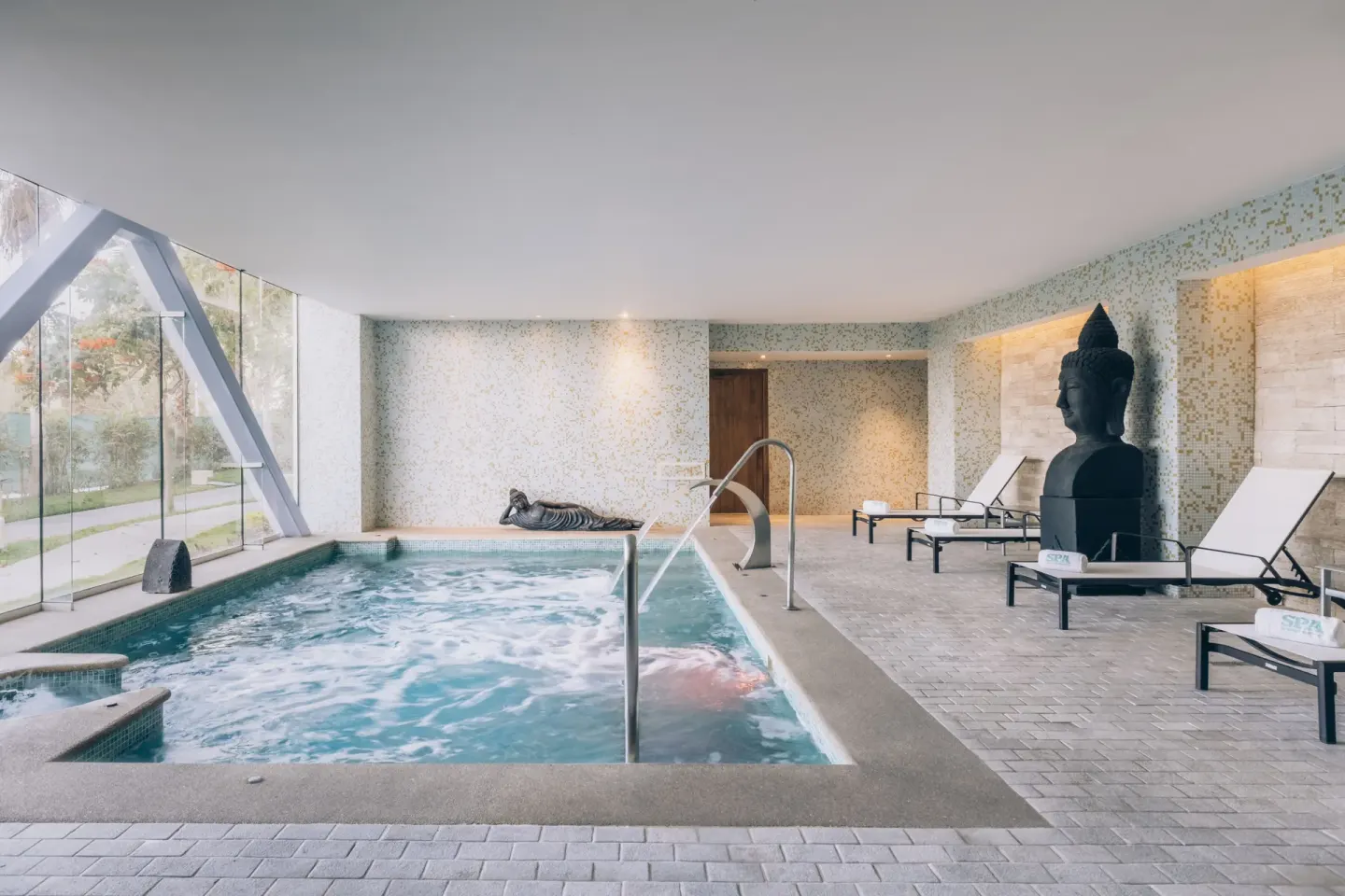 Indoor spa pool with water jets and loungers at Iberostar Selection Playa Mita.