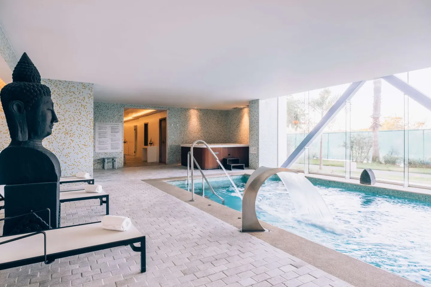 Spa pool with waterfall feature and loungers at Iberostar Selection Playa Mita.