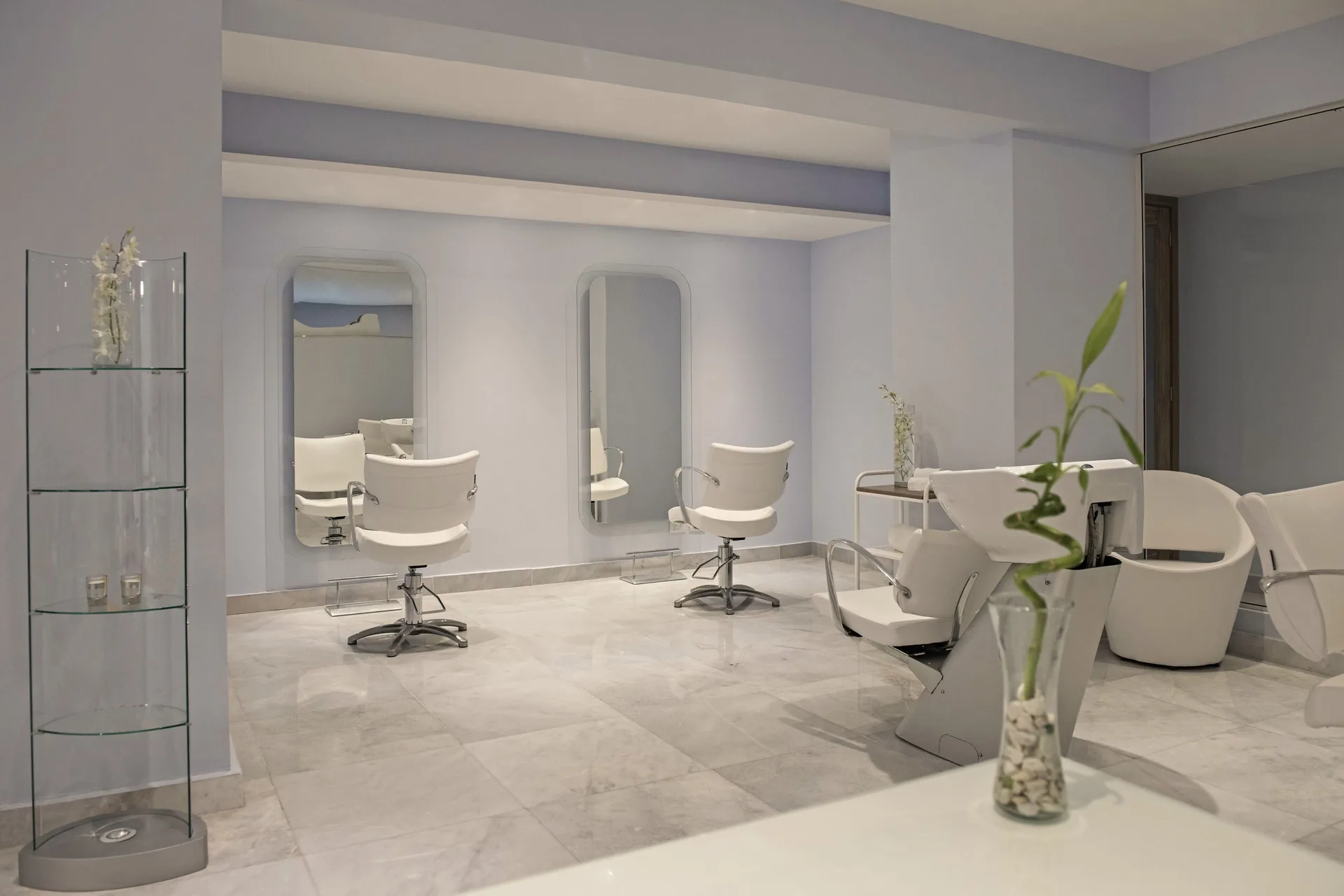 Spa salon with styling chairs, mirrors, and wash basin at Iberostar Selection Playa Mita.