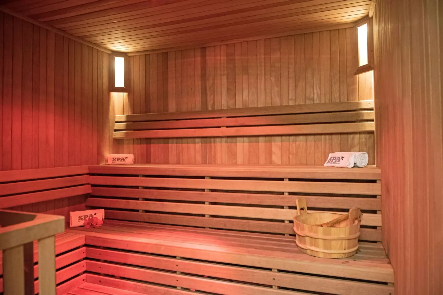 Wood-lined sauna with tiered benches and bucket at Iberostar Selection Playa Mita.