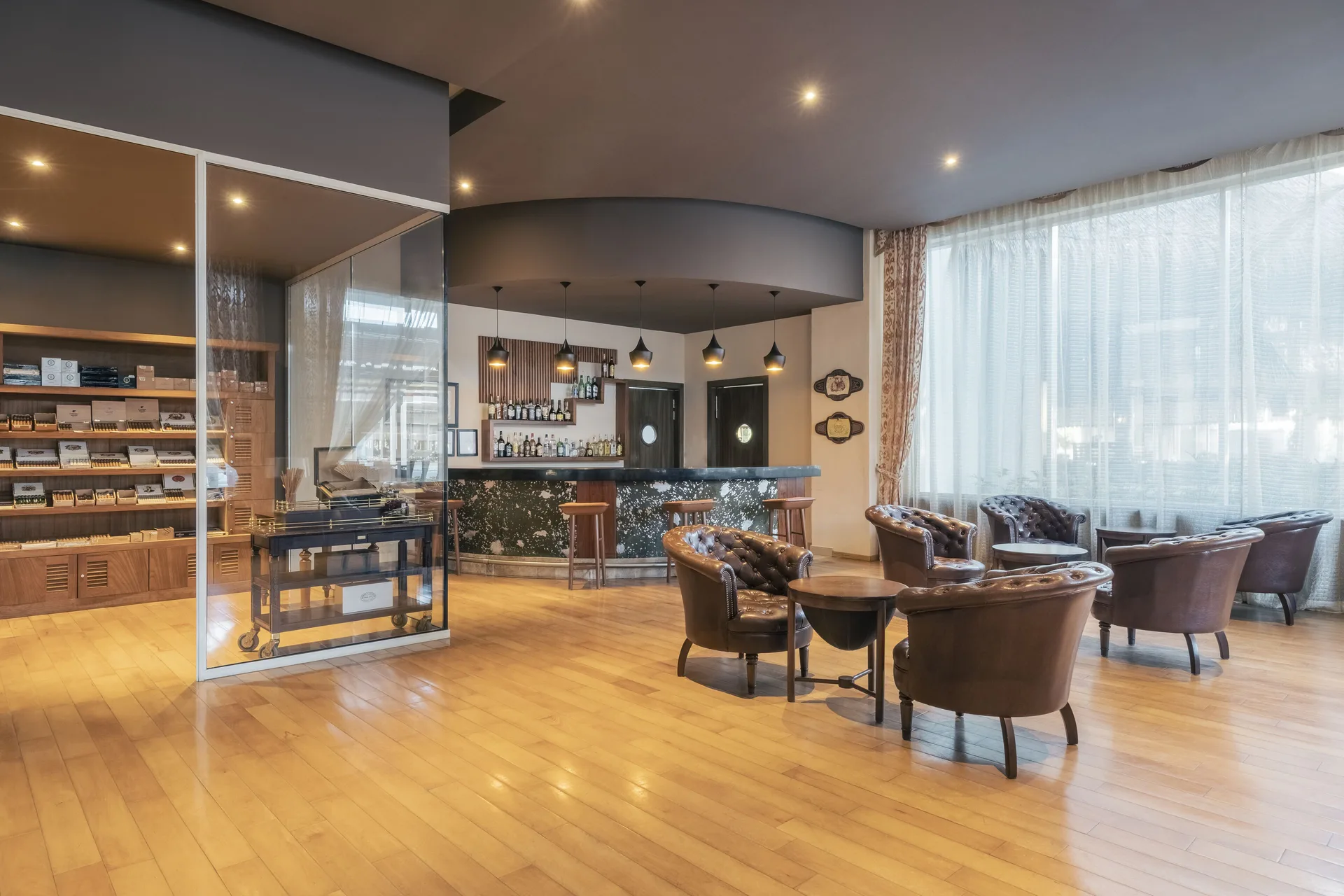 Lobby lounge with leather chairs, bar seating, and cigar displays at Iberostar Selection Playa Mita.