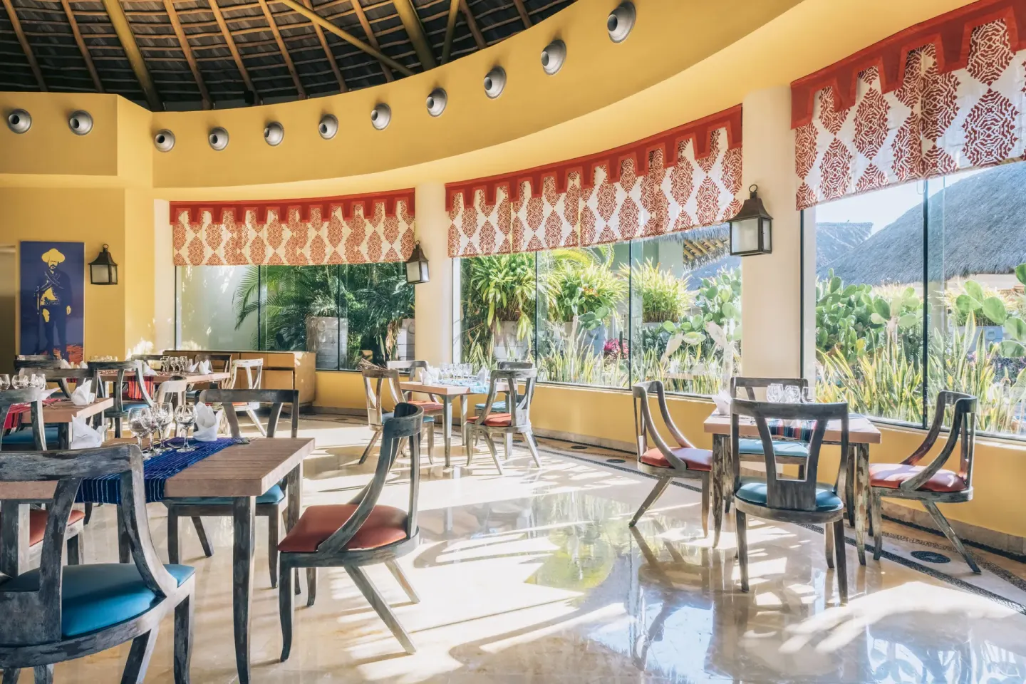 Sunlit Mexican-style dining room with garden windows at Iberostar Selection Playa Mita.