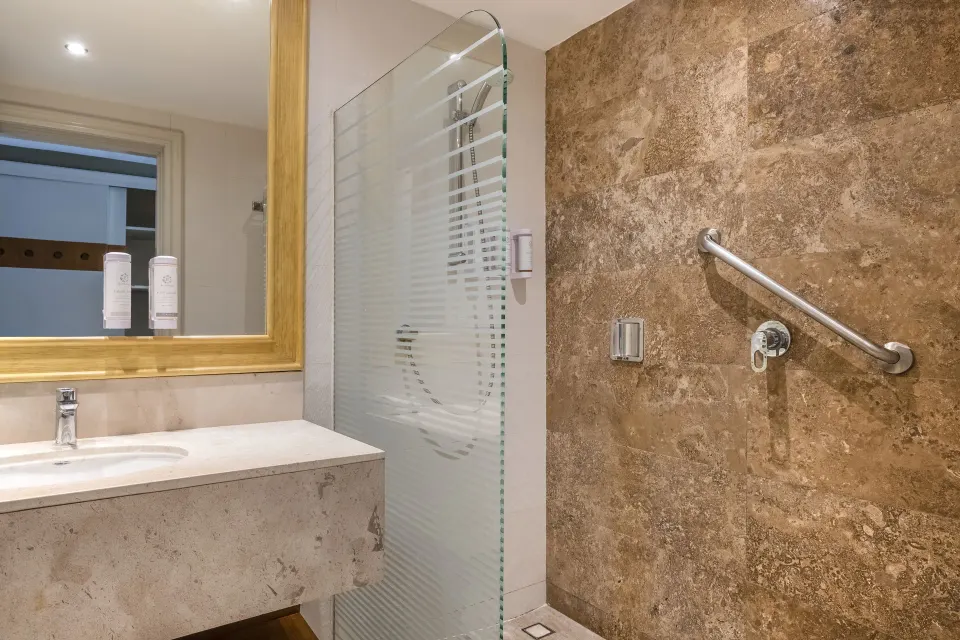 Junior Suite beach access bathroom with vanity and walk-in shower at Iberostar Selection Playa Mita.
