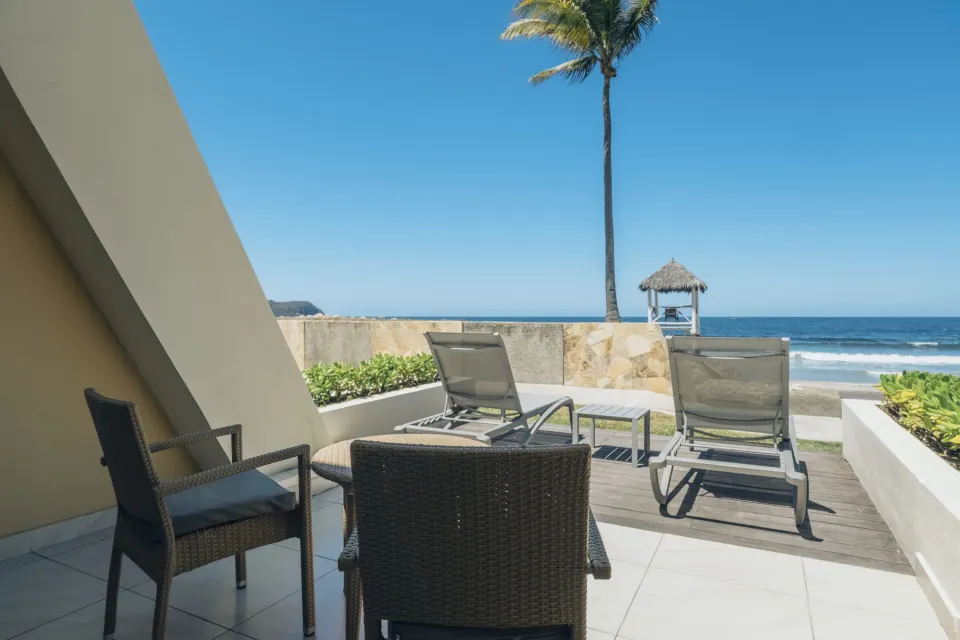 Junior Suite beach access patio with loungers and ocean view at Iberostar Selection Playa Mita.