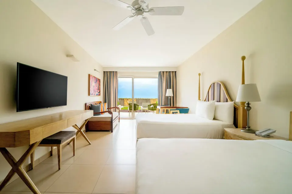 Junior Suite beach access with two beds and ocean-facing patio at Iberostar Selection Playa Mita.