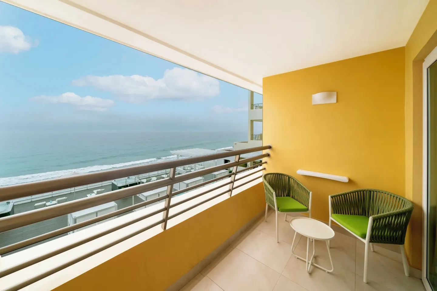 Oceanfront junior suite balcony with chairs at Iberostar Selection Playa Mita.