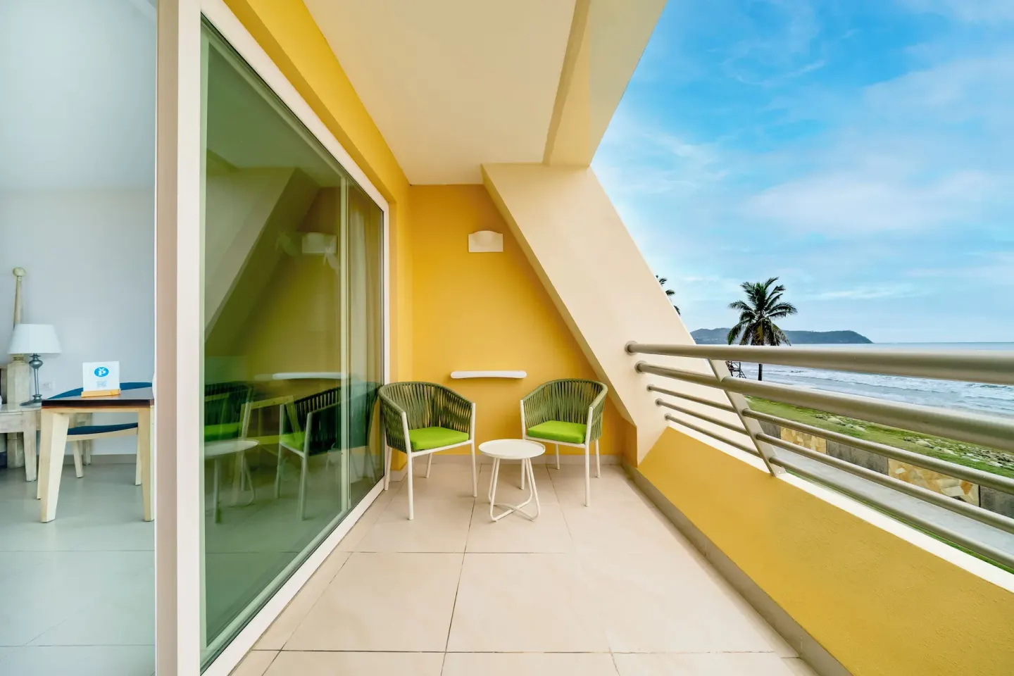 Oceanfront junior suite balcony with seating and coastline at Iberostar Selection Playa Mita.