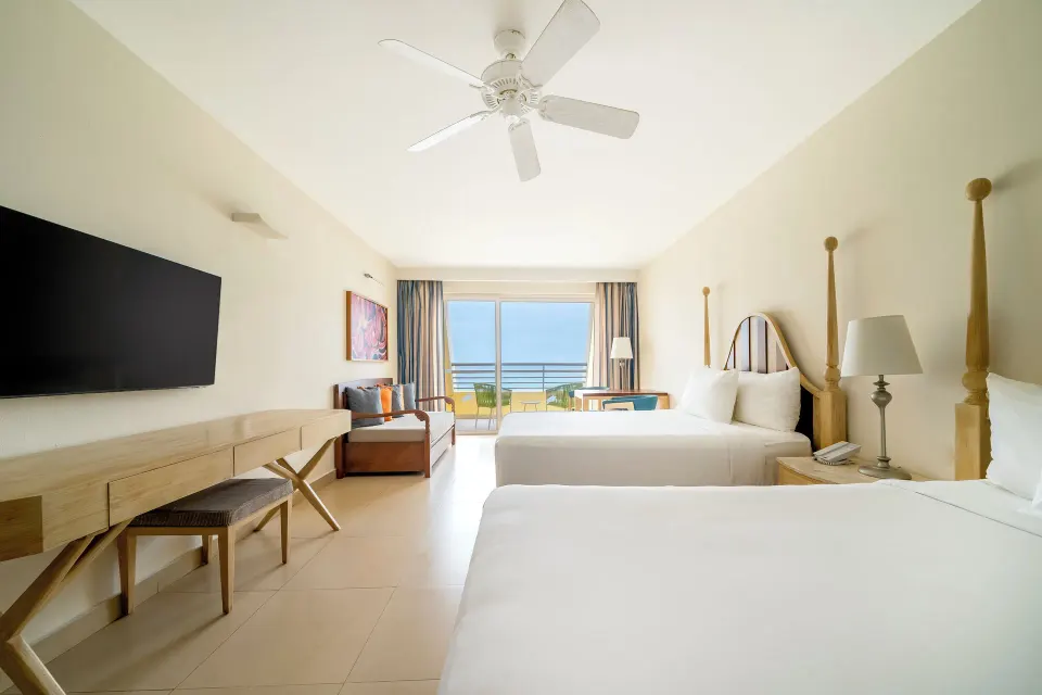 Oceanfront junior suite with two beds and balcony view at Iberostar Selection Playa Mita.