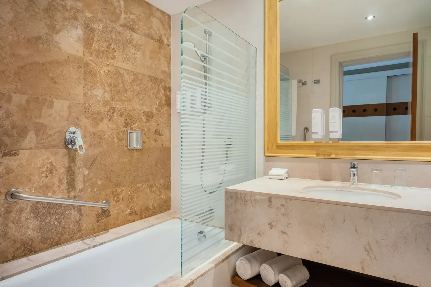 Premium Room bathroom with tub, shower screen, and vanity at Iberostar Selection Playa Mita.