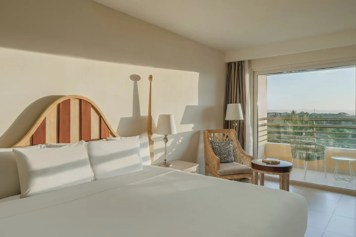 Premium Room king bed beside a balcony at Iberostar Selection Playa Mita.