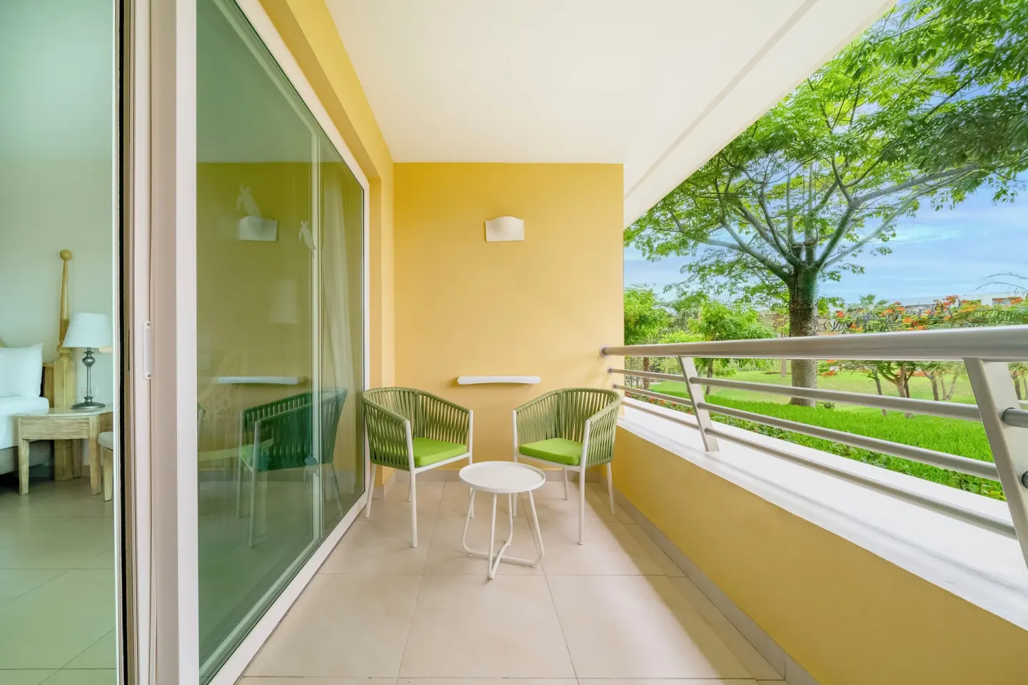 Premium Room balcony with chairs and garden view at Iberostar Selection Playa Mita.