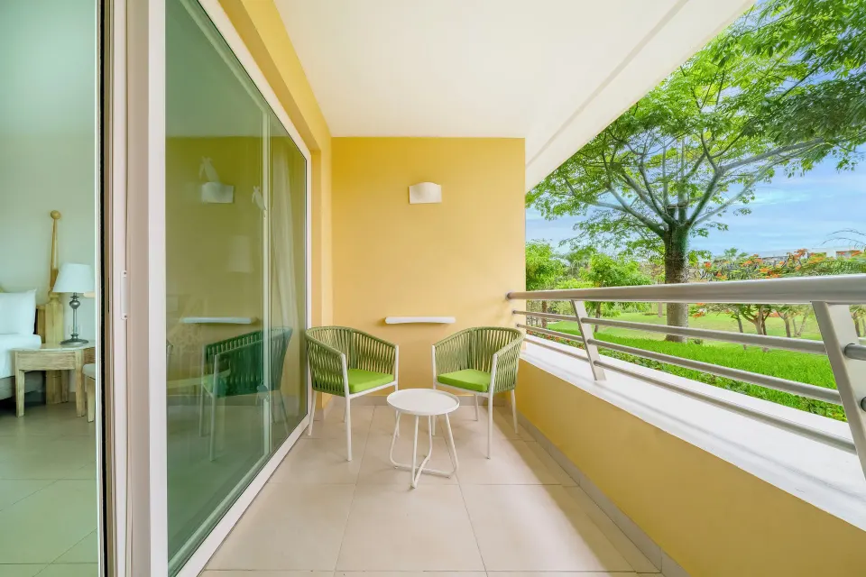 Premium Room balcony with chairs and garden view at Iberostar Selection Playa Mita.