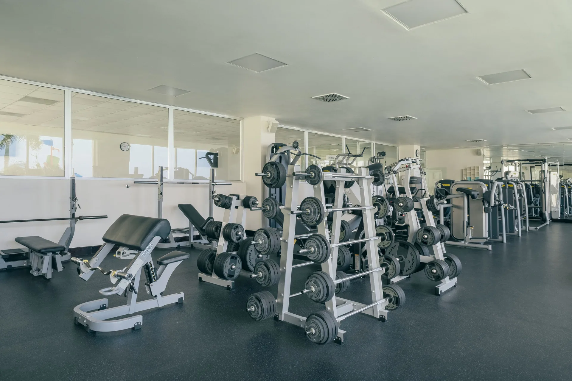 Fitness center with weight machines and benches at Iberostar Selection Rose Hall Suites.