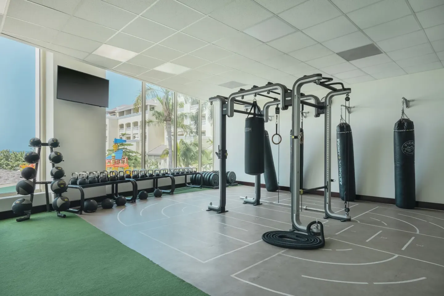 Fitness area with kettlebells and punching bags at Iberostar Selection Rose Hall Suites.