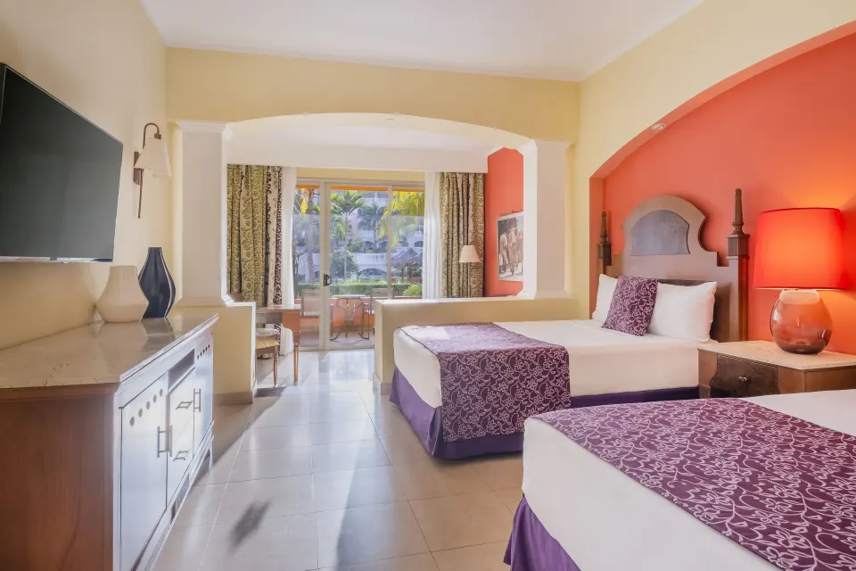Two-bed guest room with balcony at Iberostar Selection Rose Hall Suites.