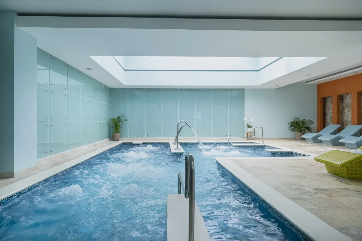 Indoor hydrotherapy pool with loungers at Iberostar Selection Rose Hall Suites.