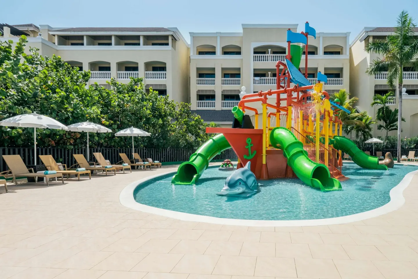 Kids' water play area with green slides at Iberostar Selection Rose Hall Suites.