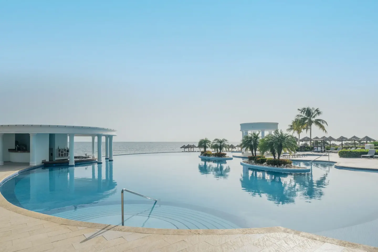Wide oceanfront pool with swim-up bar at Iberostar Selection Rose Hall Suites.