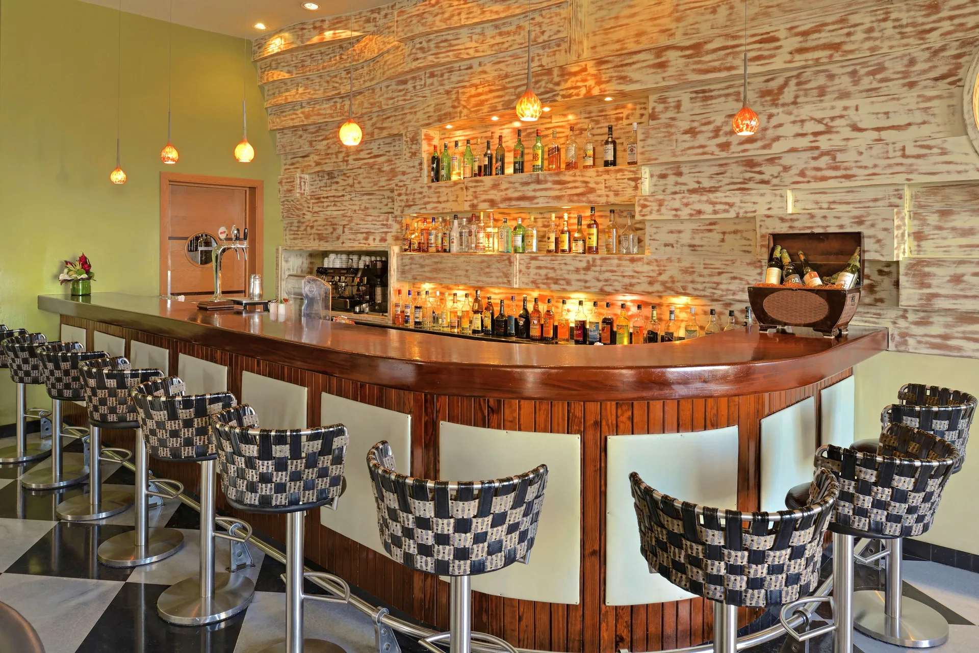 Curved bar with patterned stools at Iberostar Selection Rose Hall Suites.