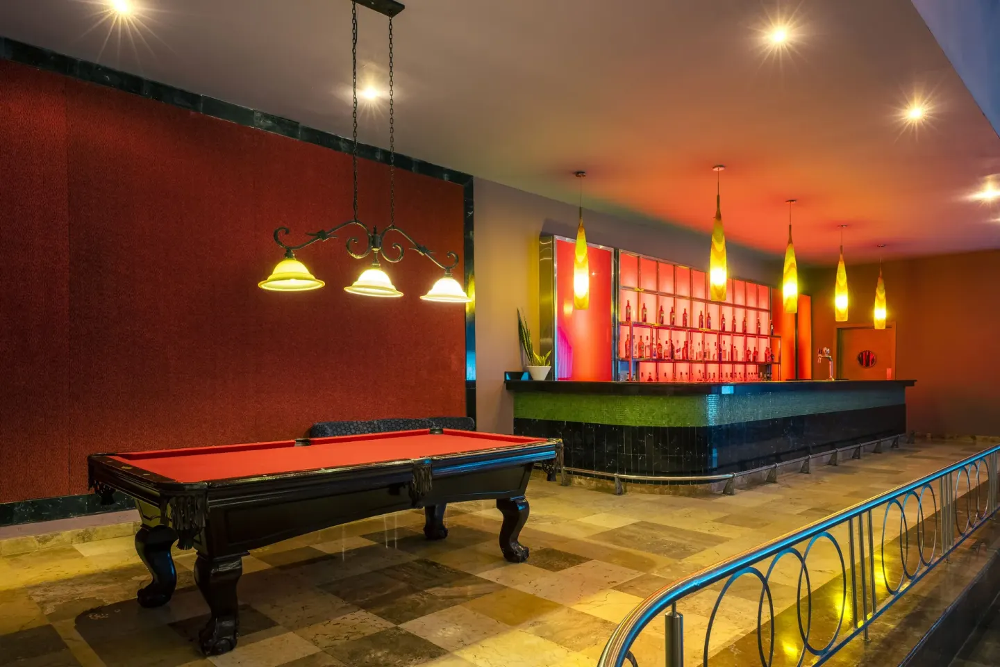 Sports bar with pool table and illuminated counter at Iberostar Selection Rose Hall Suites.