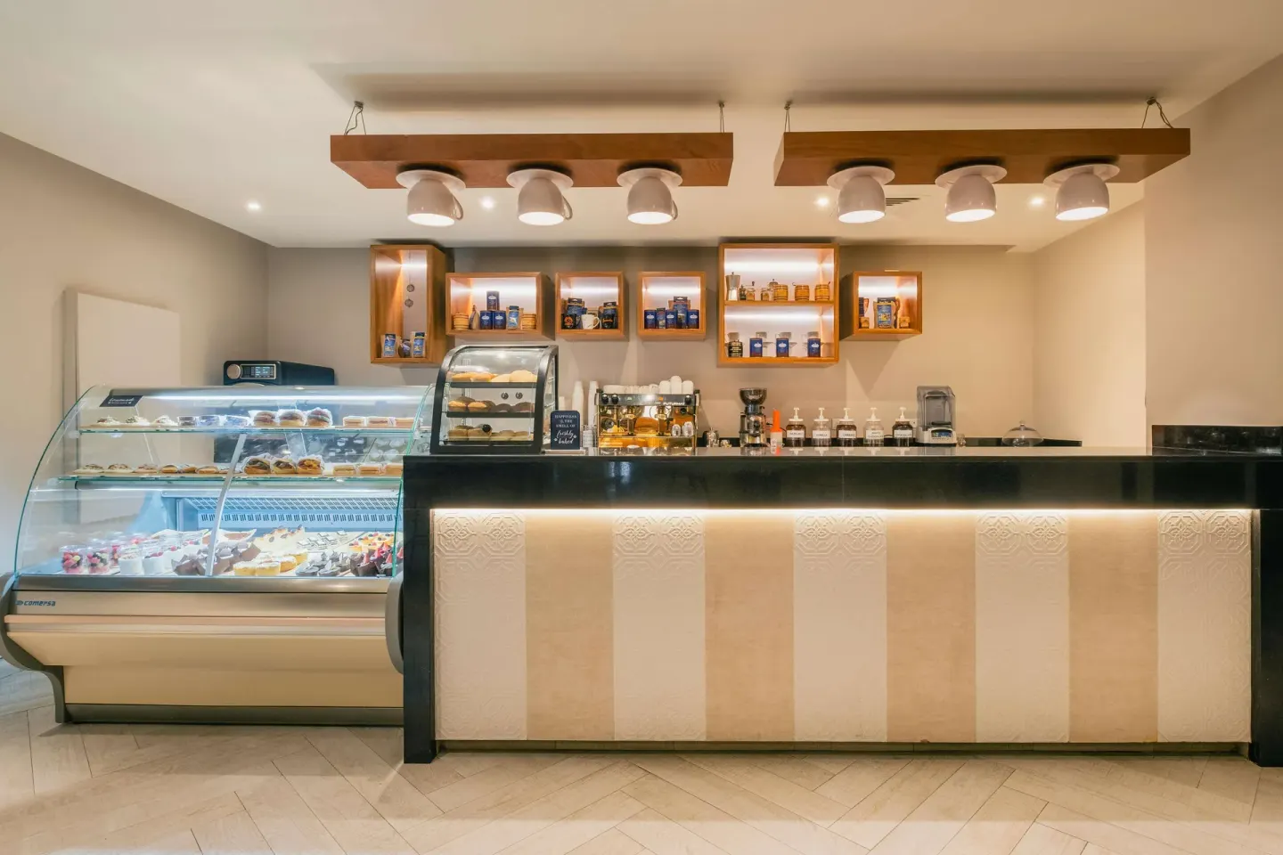 Cafe counter with pastries and display cases at Iberostar Selection Rose Hall Suites.