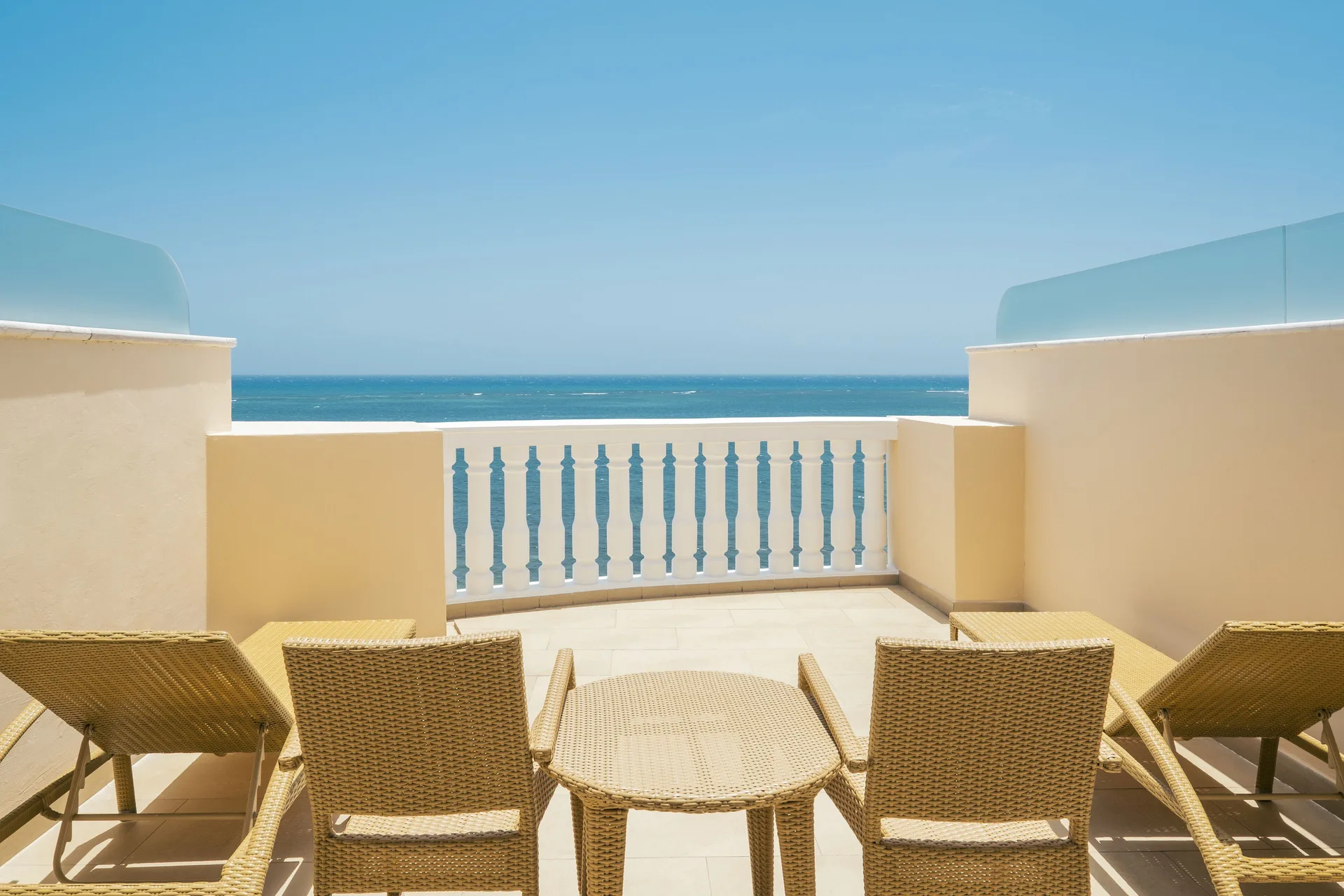 Junior Suite Ocean Front terrace seating at Iberostar Selection Rose Hall Suites with oceanfront views over the Caribbean Sea in Montego Bay, Jamaica.