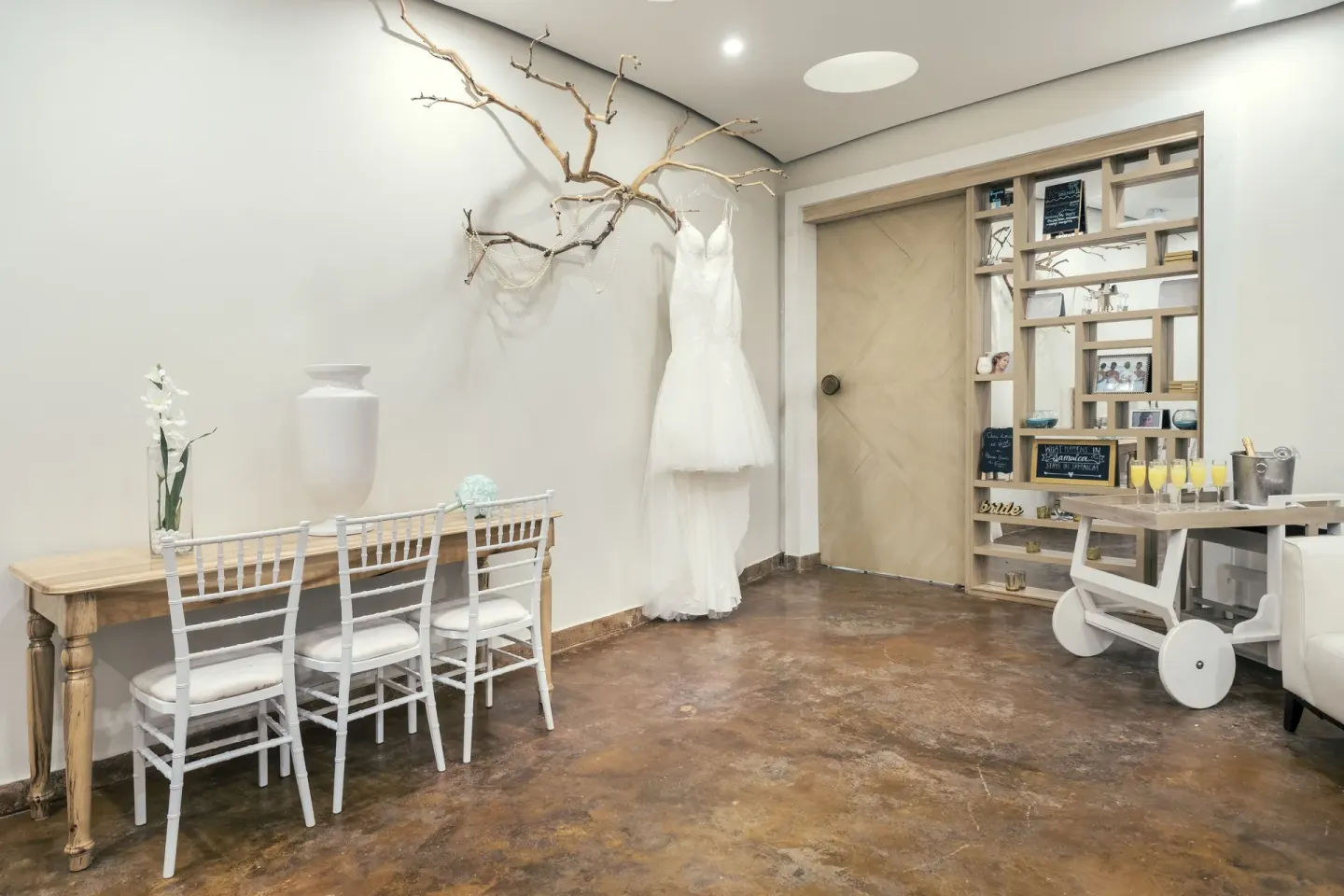 Bridal dressing room with gown and seating at Iberostar Selection Rose Hall Suites.