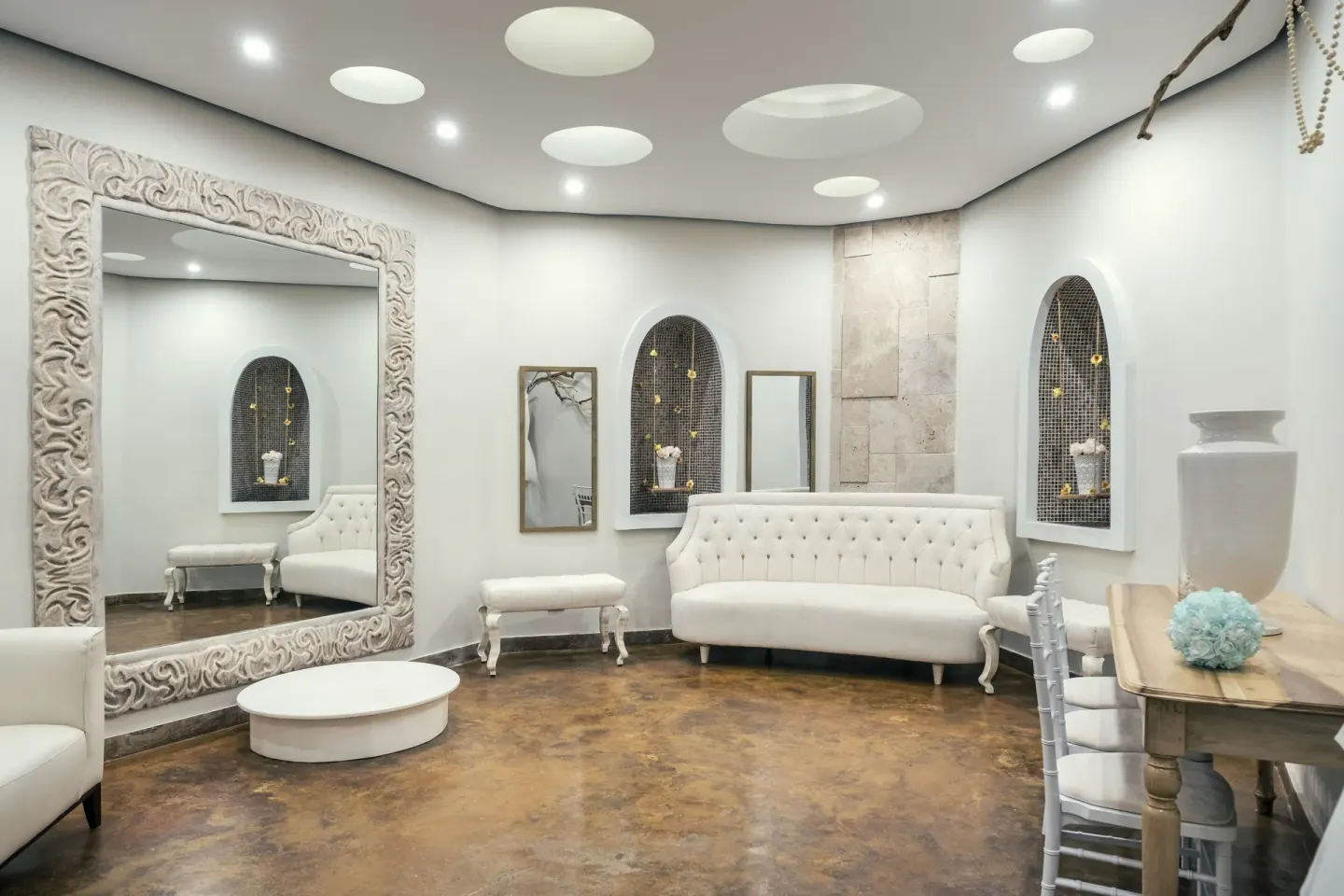 Bridal lounge with white sofa and large mirror at Iberostar Selection Rose Hall Suites.
