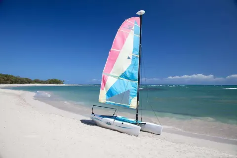 Catamaran on the white-sand beach at Iberostar Waves Costa Dorada.